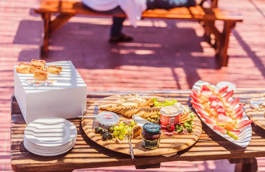 Outdoor table set with a cheese and charcuterie board