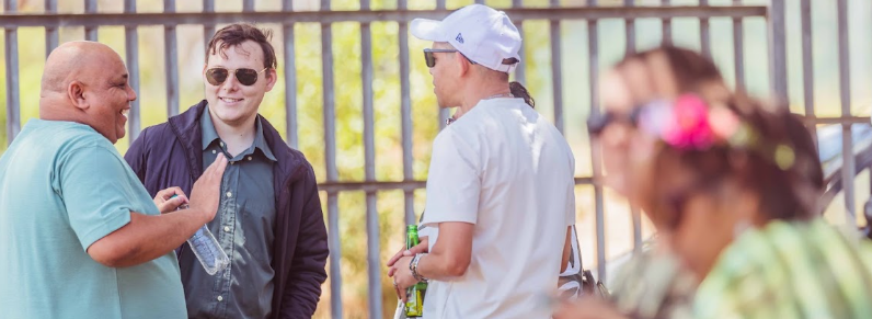 Friends chatting with drinks in the sunshine
